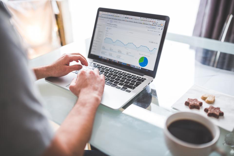 Analytics charts on a desk used to track AI tooling ROI in an MSP