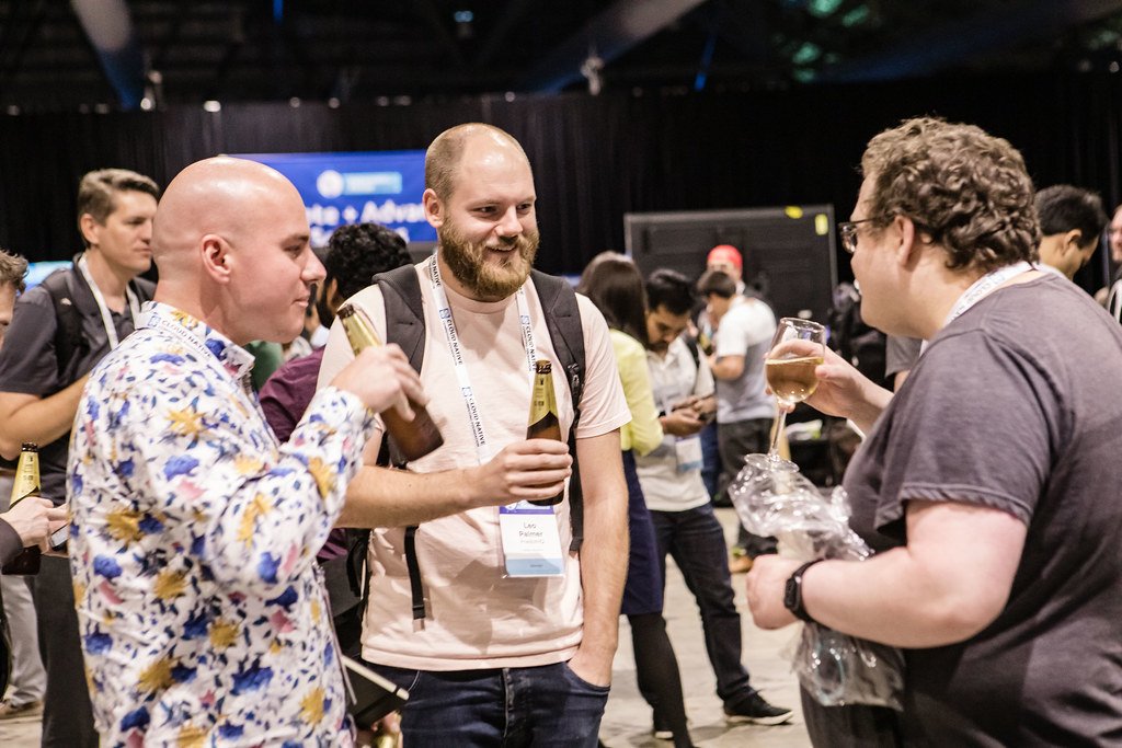 Engineers at a Kubernetes conference session, illustrating the skills a Kubernetes platform team needs