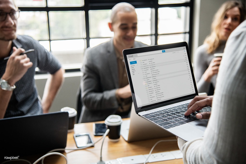 Employee reviewing shadow IT apps and unsanctioned AI tools on a laptop