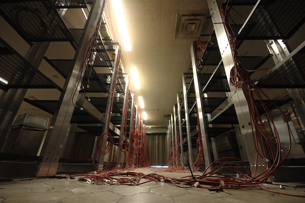 Unplugged cables on empty server shelves illustrating AI pilot decommissioning