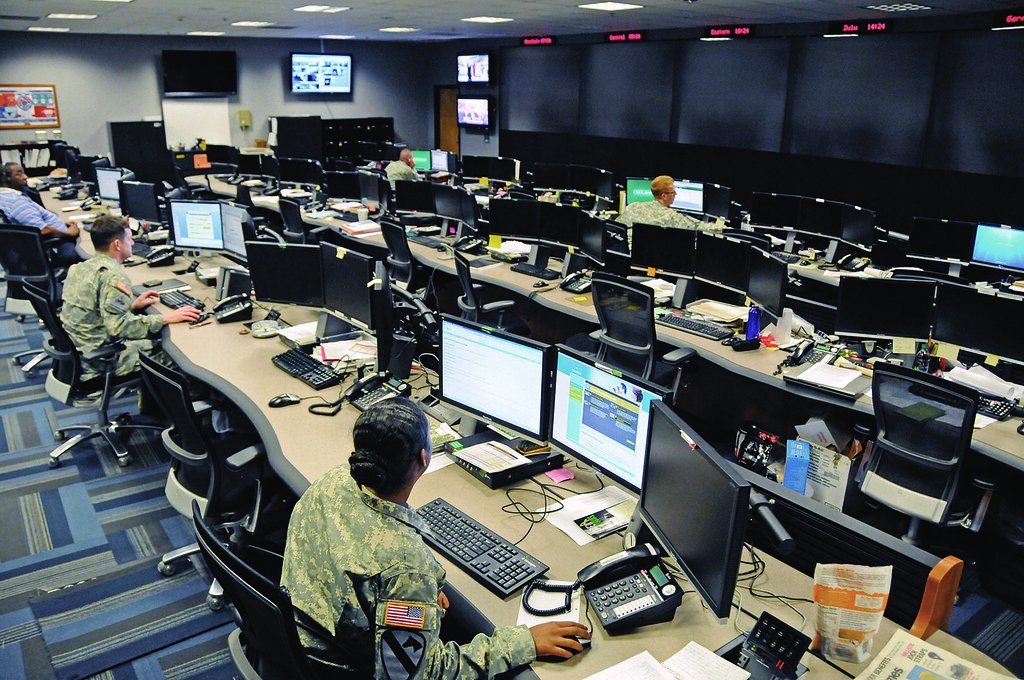 AI SOC automation in a cyber operations centre with analysts reviewing alert dashboards