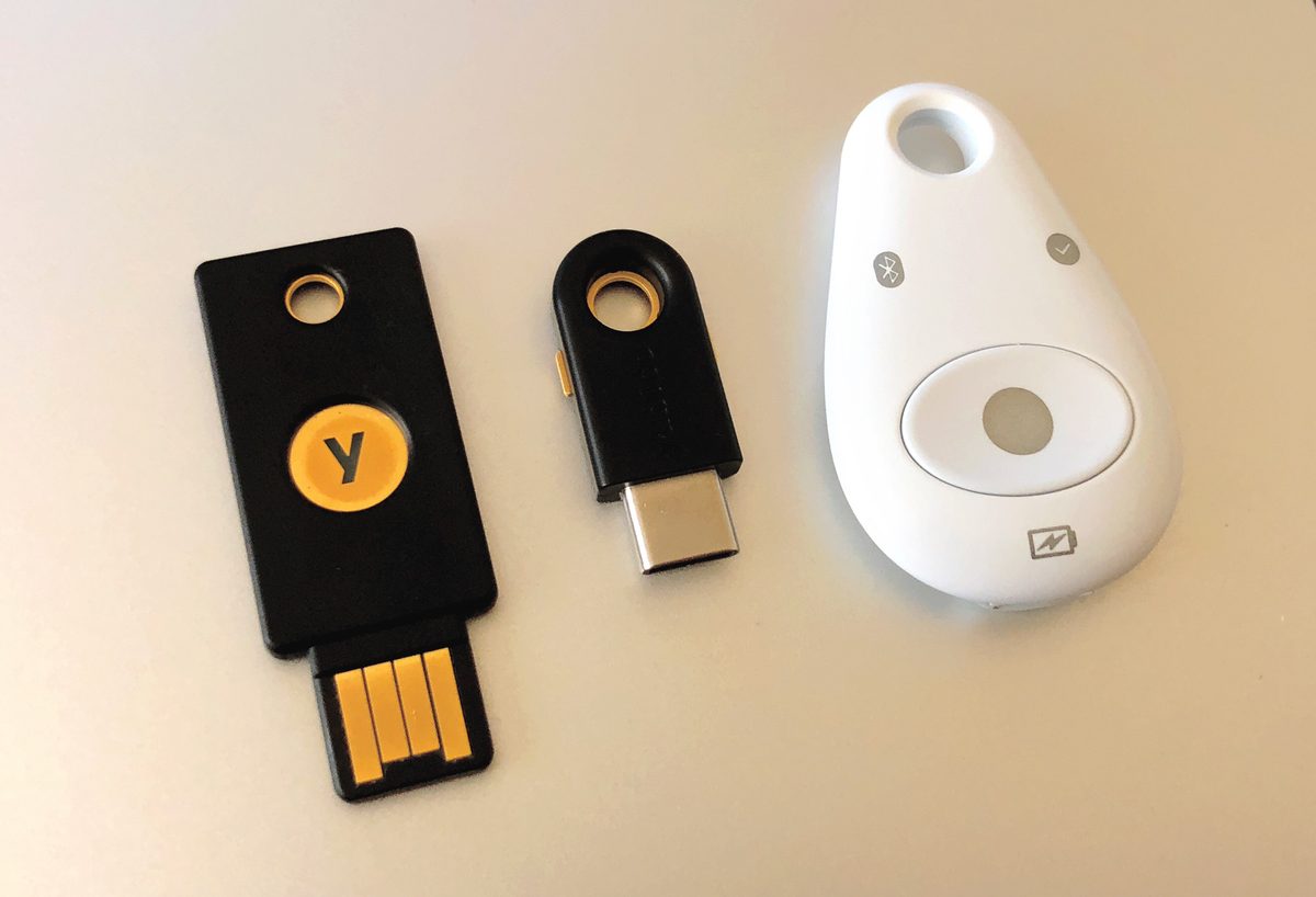Hardware security keys sit on a desk, illustrating MFA bypass prevention with phishing-resistant authenticators.